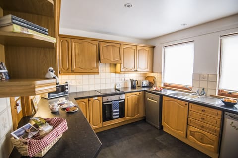 well equipped kitchen with hob, oven, fridge, dishwasher, microwave