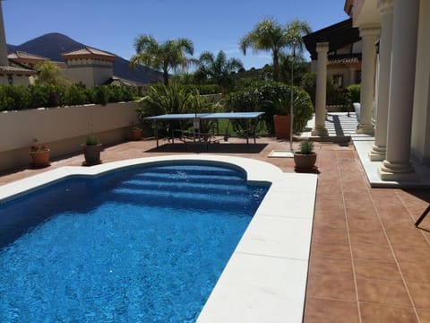 View over the pool , table tennis table, garden and veranda around the house