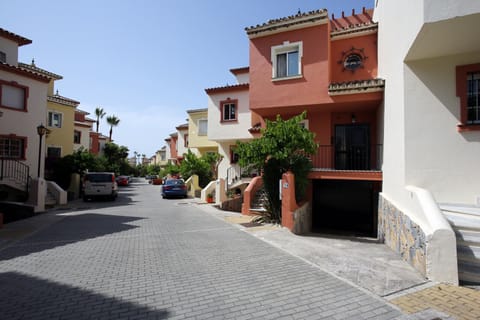 House (red) from outside. 200m down this quiet road you will find the beach!