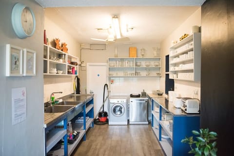 A large catering style kitchen,  American style fridge, and other appliances 