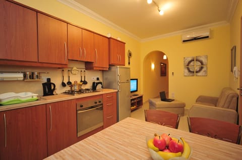 Fully equipped kitchen with hob, oven, fridge, microwave, pots, pans and cutlery