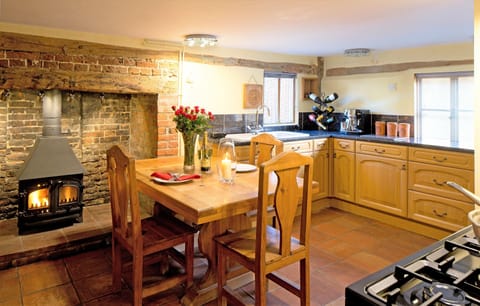 Kitchen with large inglenook fireplace.
