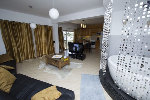 Lounge, Jacuzzi, TV, and Kitchen, Dining, and seaviews in background