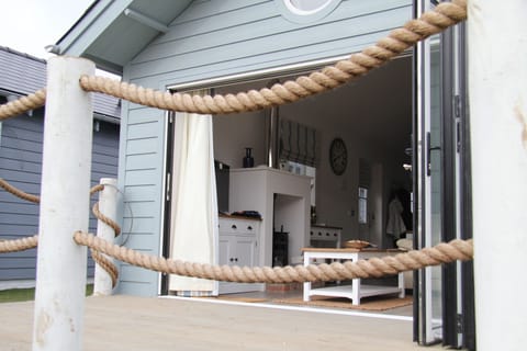 Decking area is roped off as a seating area + bench seat with beach accessories