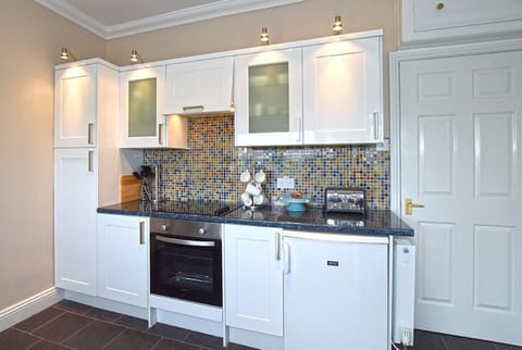 Kitchen with fridge, oven and hob.  Additional fridge/freezer in garage.