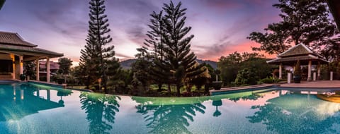 Main Pool (17M) with ample space or fun, dining and sunset views over mountains.
