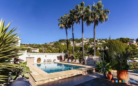 The pool with sun loungers and plants — the perfect spot for a sunset cocktail as the sky changes colour.