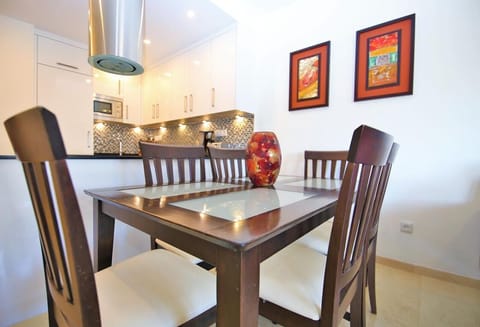Lovely dining area with seats for six is beside the kitchen bar