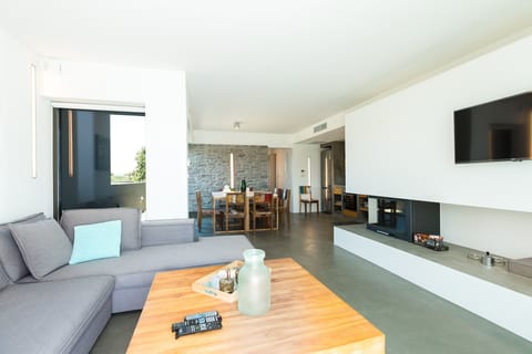 Living room with a large sofa, a fireplace, a 42” satellite HDTV