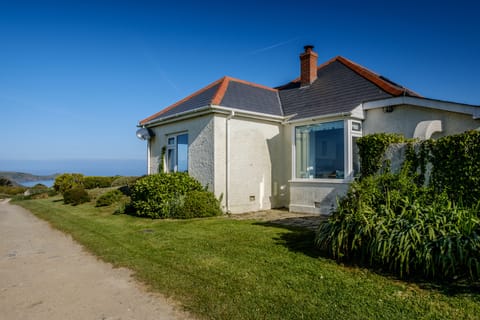 Side of house on track to sea