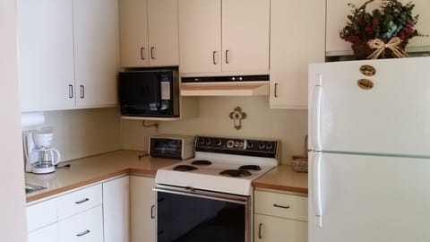 The kitchen with microwave, toaster oven, four burner electric stove and more!