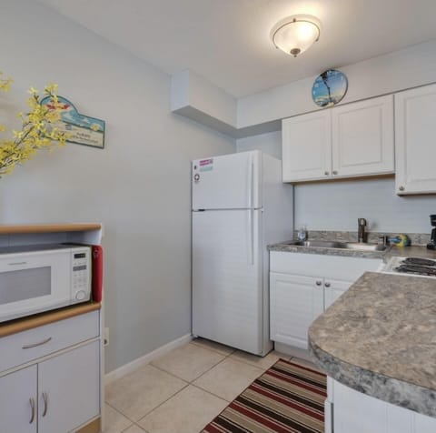 Kitchen with stove, refrigerator, microwave, toaster, coffeemaker, dishes, etc