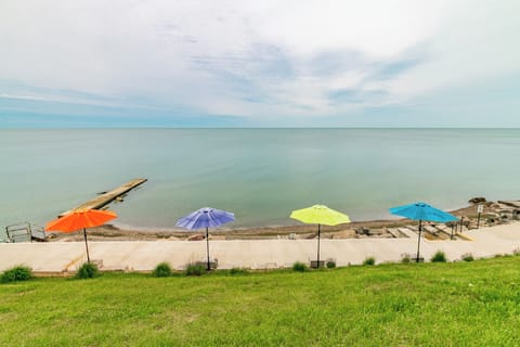 Private beach with concrete boardwalk.