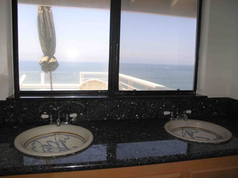 Master bathroom overlooks the upper deck and ocean views!