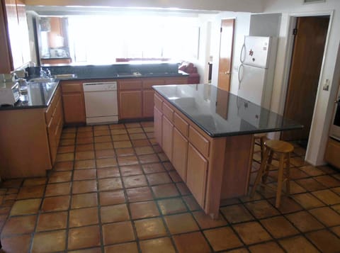 Fully equipped kitchen has ocean views across the family room