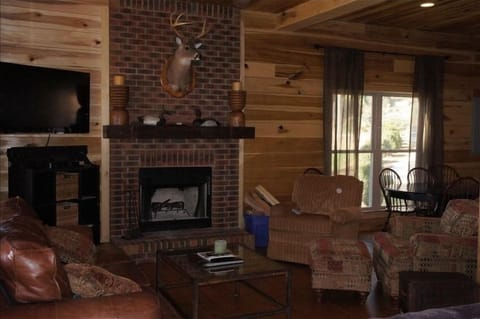 The living room features wood walls and ceilings, and wood floors throughout.