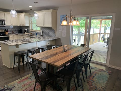 Dining table with 8 chairs and 4 bar stools at island w/views of the lake