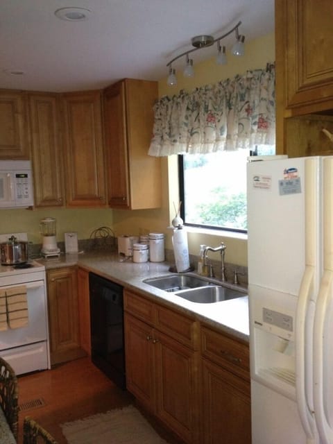 New cabinets, granite and eating bar/desk make an efficient kitchen! Treed view