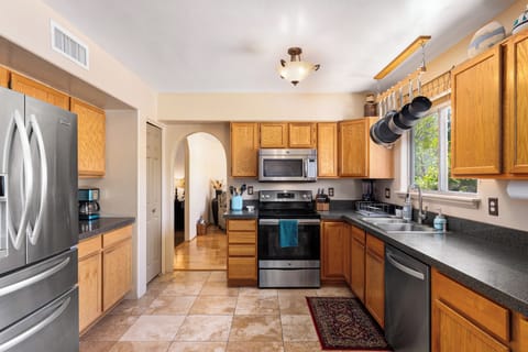 Very well equipped kitchen with lovely views over the backyard and pool