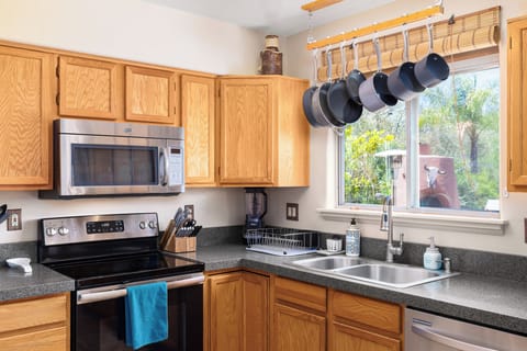 Well stocked kitchen with lovely views over the backyard