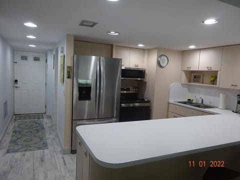 View of kitchen and entrance from livingroom