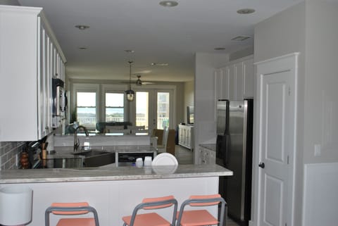 Kitchen opens into the living room dining room with a water view.
