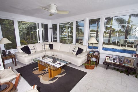 Living room, pool and water beyond, and bird feeders on left 