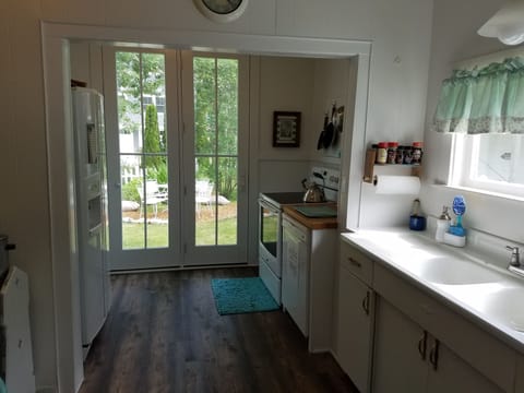 Downstairs kitchen adjoins the back garden through French doors.