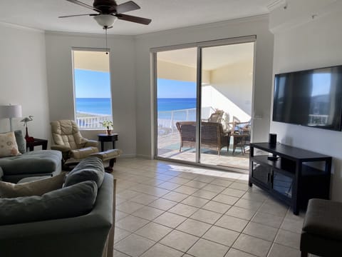 Beautiful Beach Views with a large comfortable couch and a 65"  smart TV