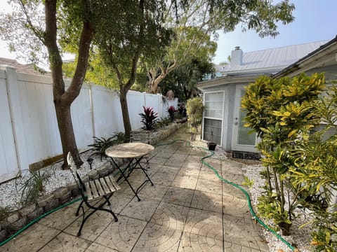 Fenced backyard with small portable grill