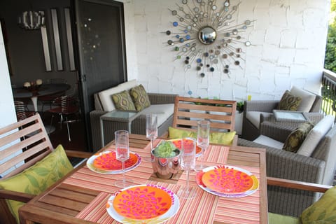 Patio dining and sitting area overlooking pool