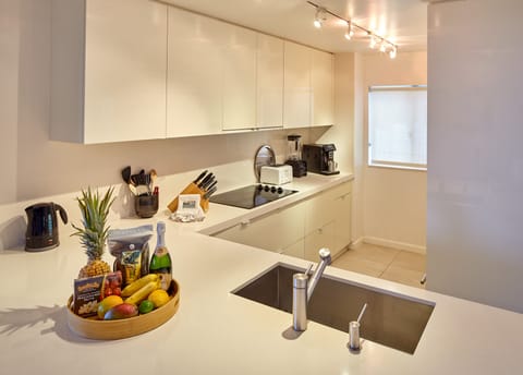 Generous work spaces, easy-clean surfaces in white-on-white kitchen