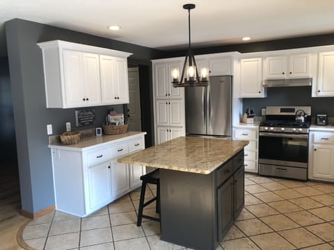 kitchen with granite topped island and seating for two