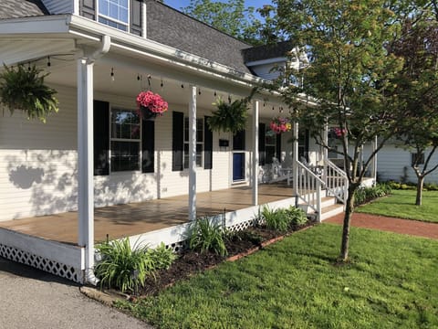 Beautiful landscaping, 8 hanging baskets on porch and Edison style lights
