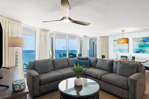 Spacious sectional sofa and dining area as viewed from primary suite entrance