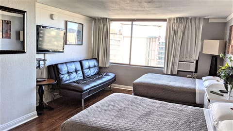 Studio A with two queen beds, convertible sofa/bed and window air conditioner.