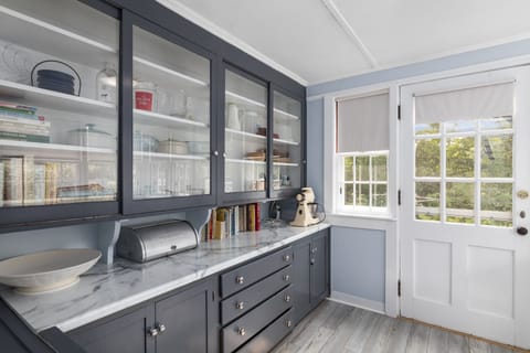 Laundry contains additional kitchen storage. Door leads to outside left.