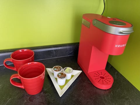 Coffee maker and a few K-cup pods are provided. 