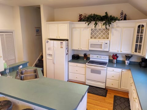 Spacious well-stocked kitchen with lots of counter space, cabinets and drawers.