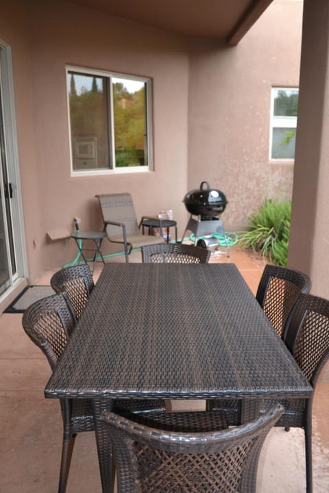 Back patio with seating for 6 and charcoal grill.
