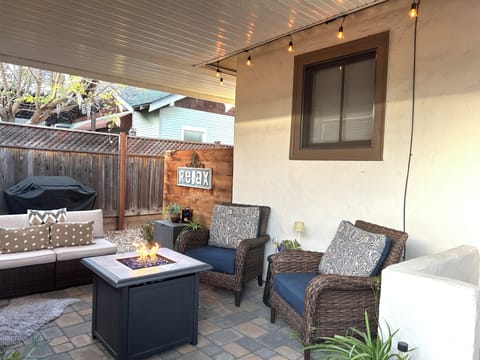 The Private Patio w/Comfy Chairs, Outdoor Sofa, Fire Pit, Party Lights, BBQ.
