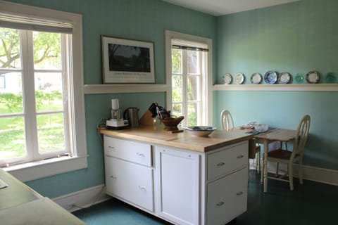 Kitchen overlooking nook area. Crisp white pairs perfectly with green contrast.