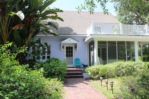 Front view of the home with screened porch, second-floor porch, & sun porch.
