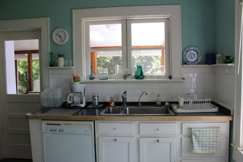Light kitchen with crisp white subway tiles contrasting perfectly with the green