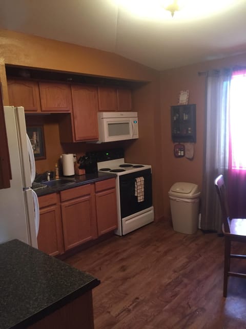 Full Kitchen stocked with pots,pans,utensils,plates and glasses