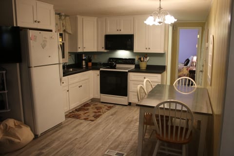 kitchen open to living room new floors and cabinets