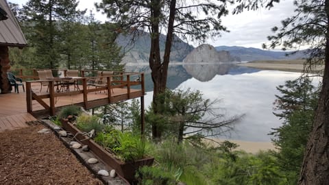 Cabin deck with view of lake and white stone rock