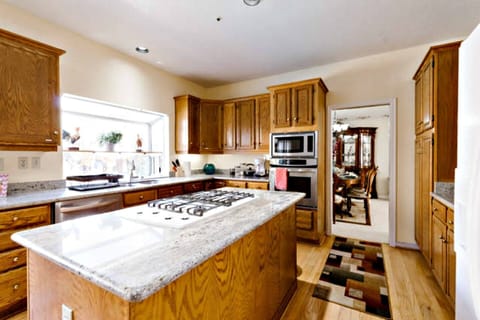 Kitchen with granite countertop, island, stainless steel appliances