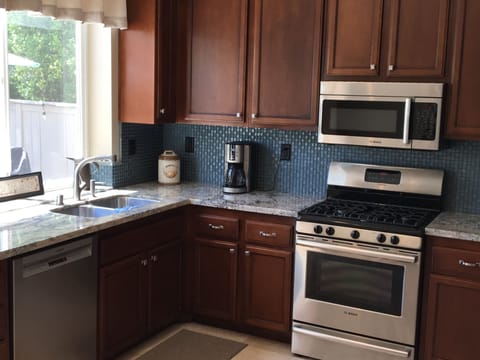 Bright open kitchen with new granite countertops.