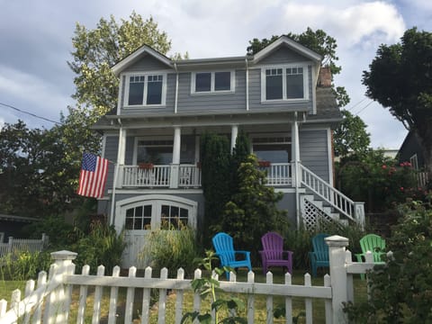 Colorful Adirondack chairs adorn front lawn